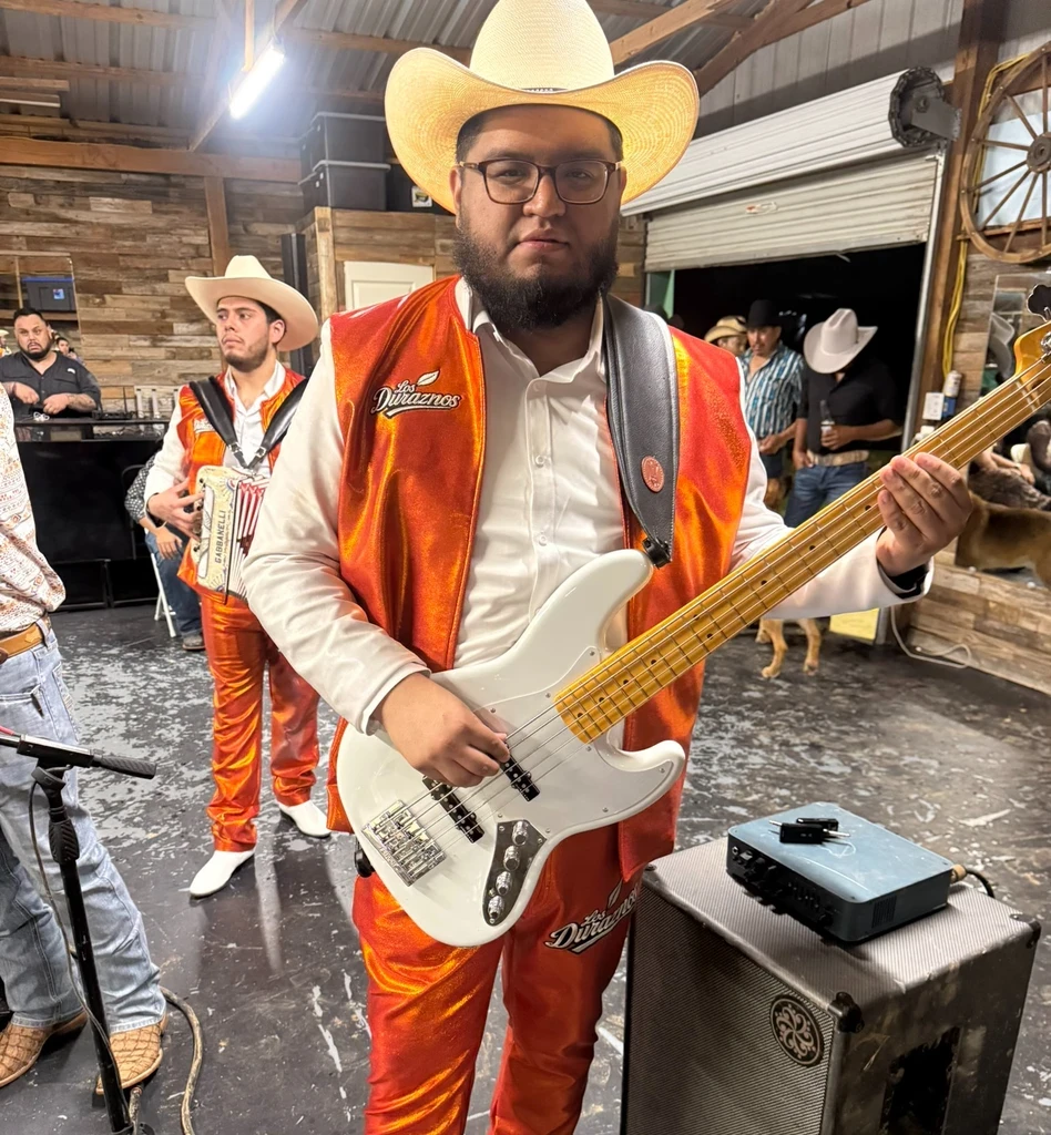 Bryan playing bass guitar on stage