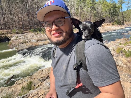 Bryan hiking with his dog by a waterfall